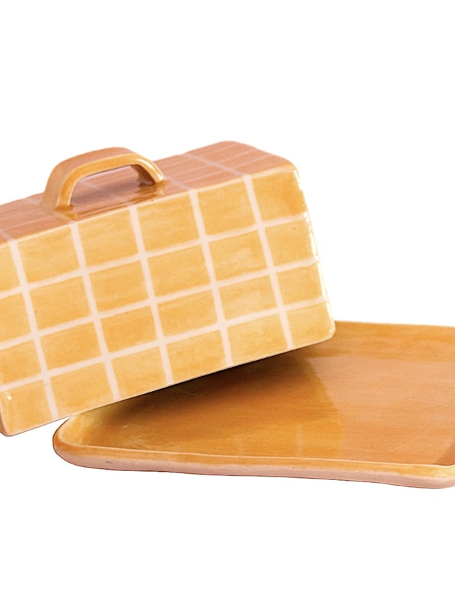 Grid Butter Dish, a colourful butter dish with a grid pattern sitting on a white tabletop surface. 