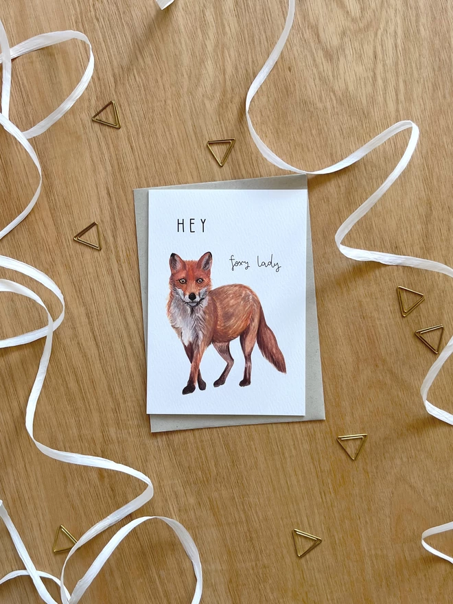 a greetings card featuring a fox illustration and the text “hey foxy lady”