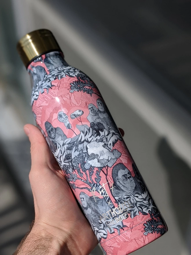 hand holding gorillas sustainable insulated charity water bottle with pink & black gorilla illustrations