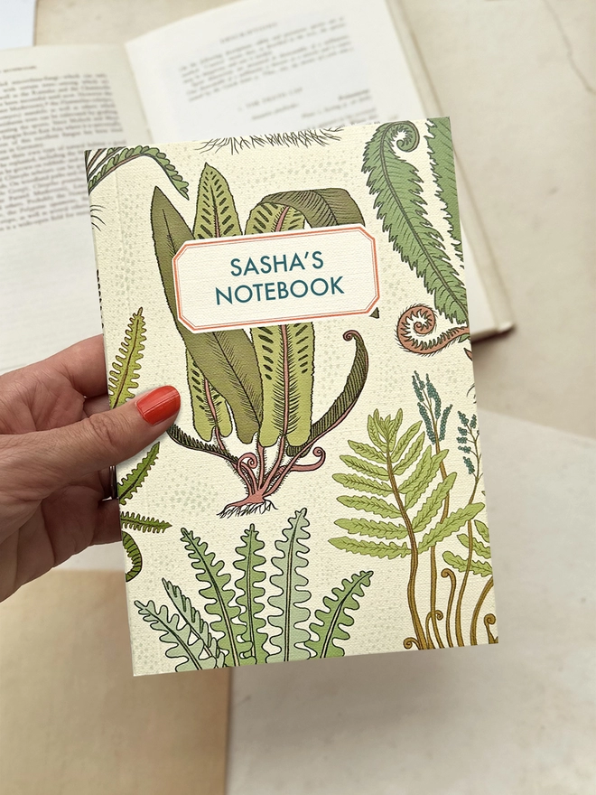 HOLDING THE FERN NOTEBOOK