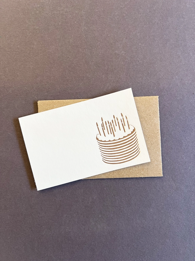 Cake tiny note on top of a brown envelope.