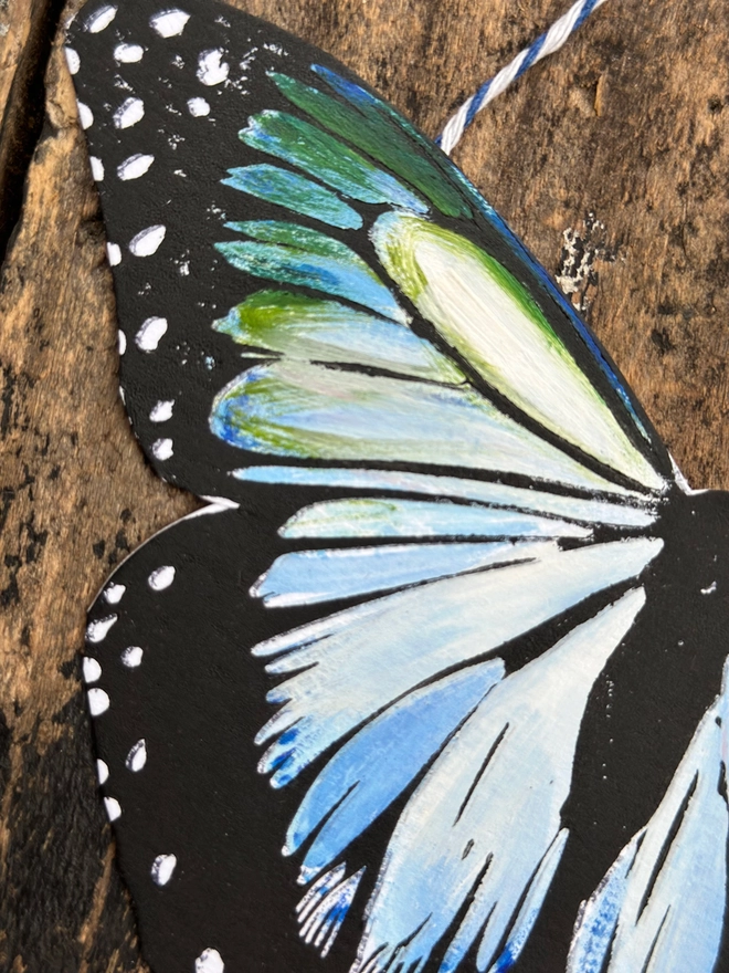close up of a Hand Painted Butterfly Colourful Linocut Hanging Decoration In blue green and black