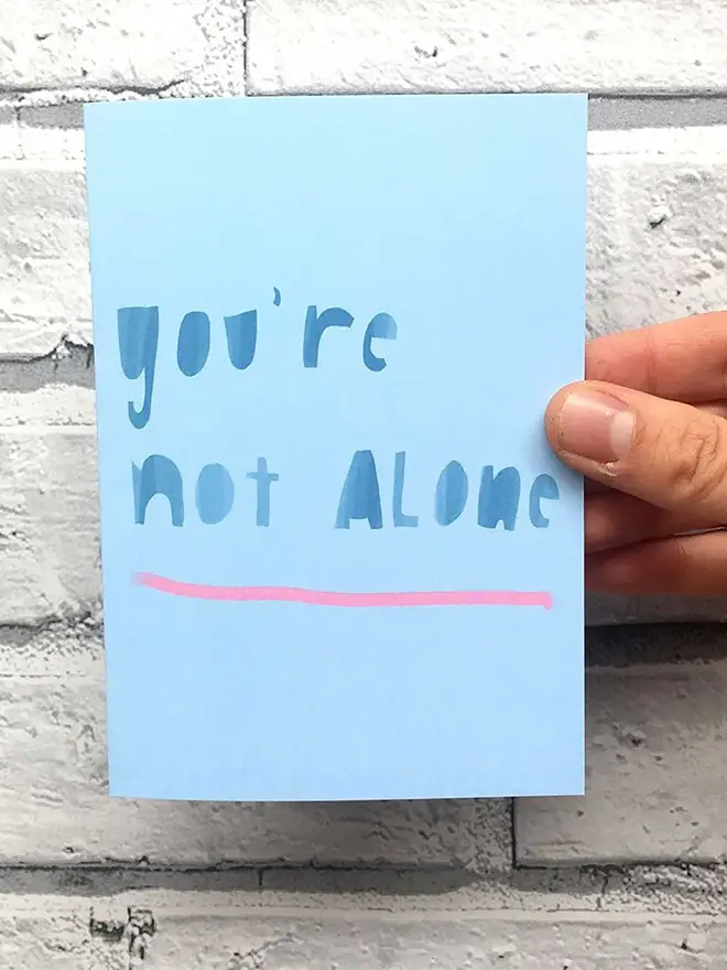 Card reads 'you're not alone' 