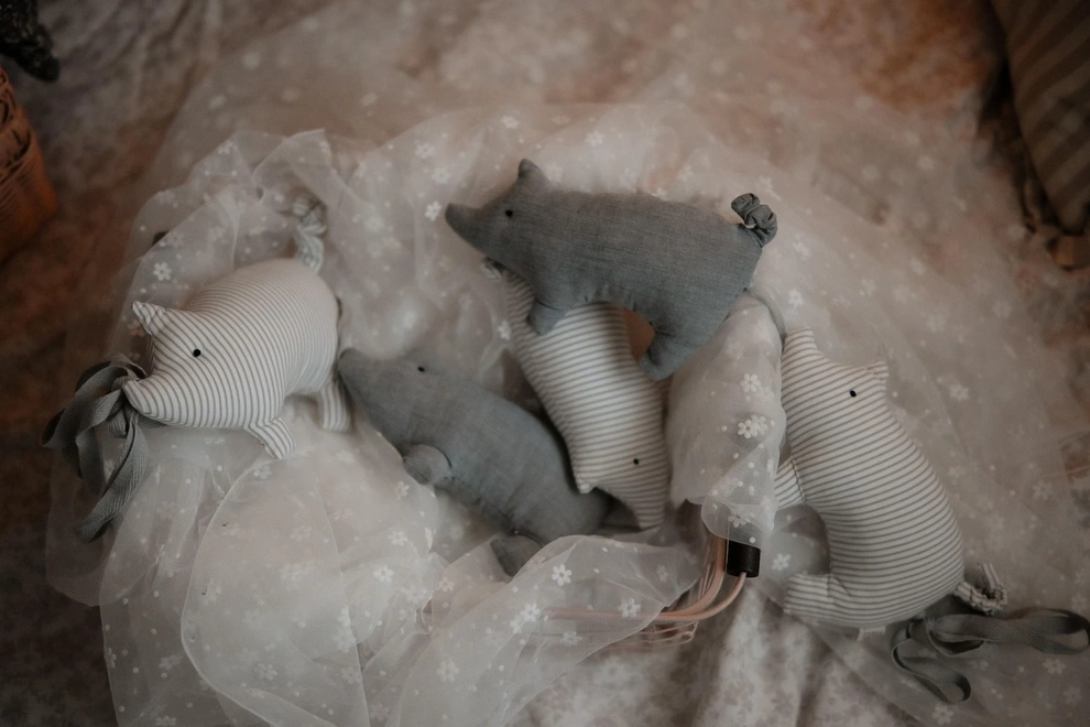 Pig Garland Decoration, a grey and white pig garland decoration in a child's bedroom. It is accompanied by other bedroom accessories. 