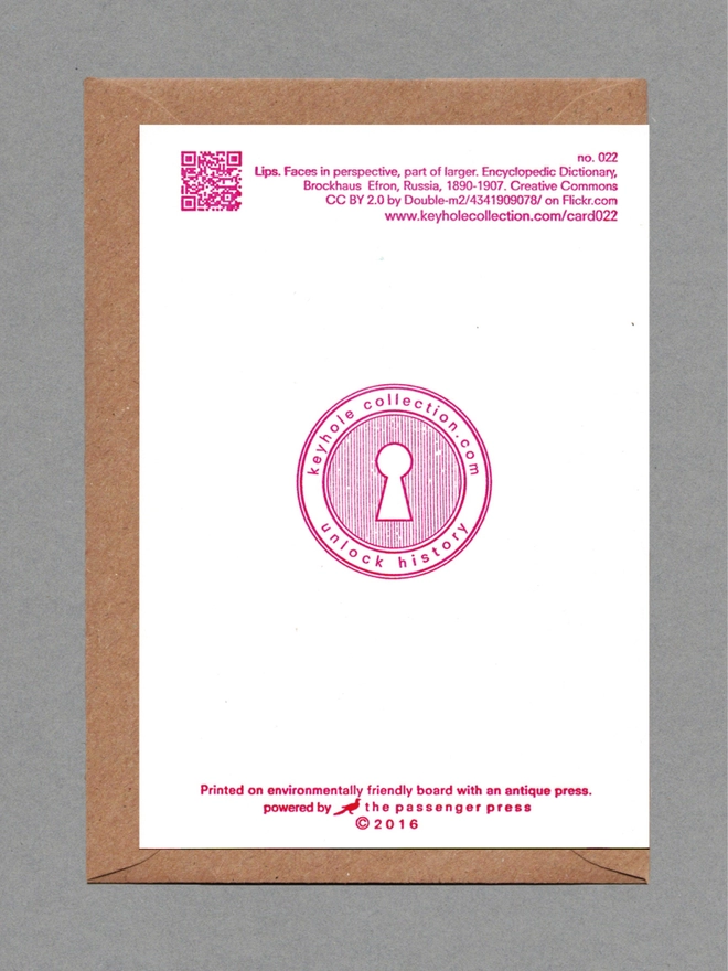 Back face of a white card on a brown envelope. Printed pink text, logo and QR code.