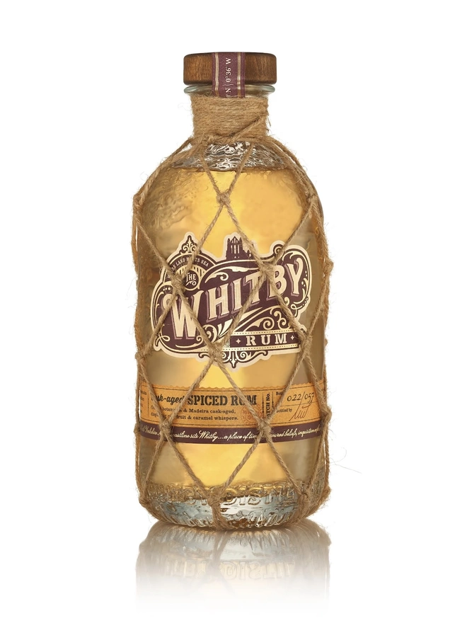 Whitby Rum, a bottle of rum sitting on a plain white surface. 