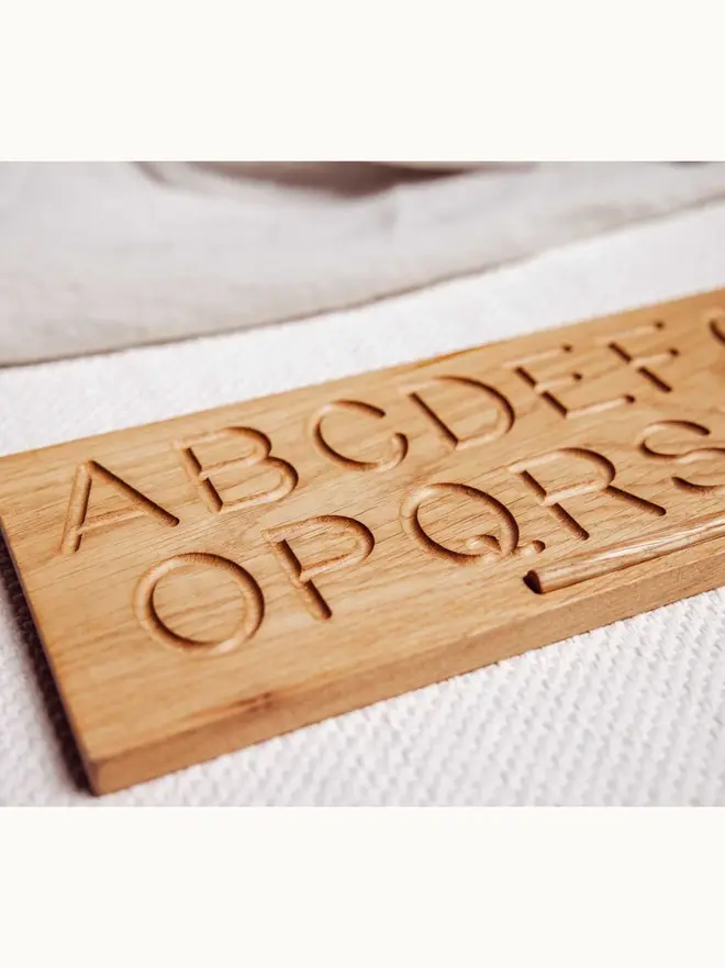 Wooden Alphabet Tracing Board Heirloom Toy, on a table. 