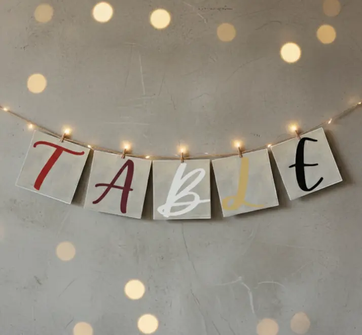 Hand Painted Alphabet Initials Linen Table Napkins, an initial napkin set spelling out 'table' hanging from a line