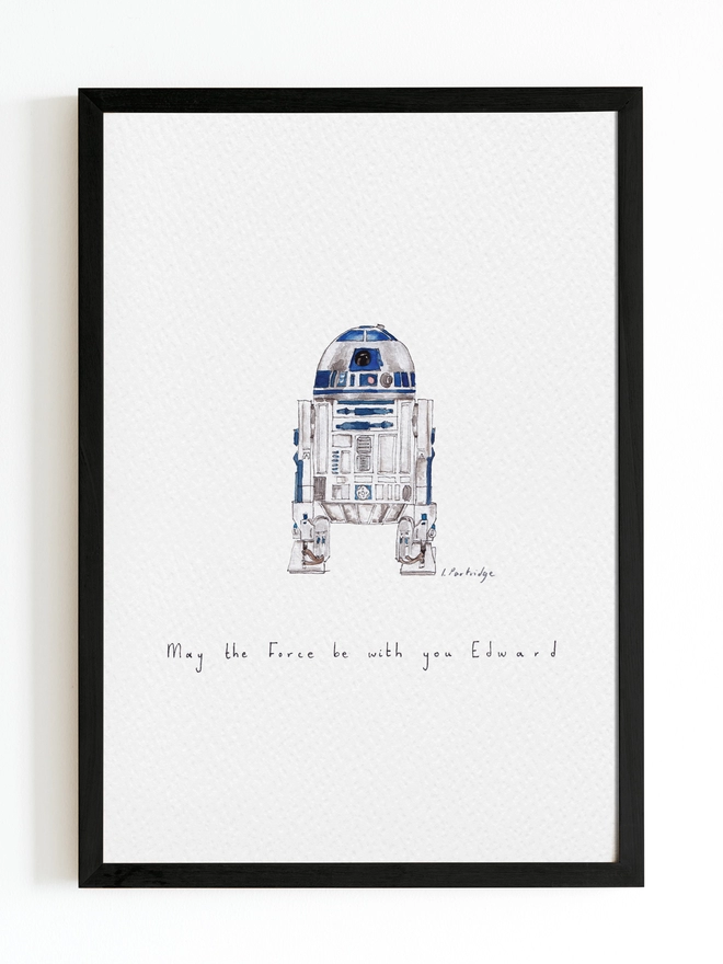 Hand drawn and painted watercolour illustration of R2D2 with a detailed yet organic and slightly loose style. Hand written text below reads ‘May the Force be with you Edward’. The painting is a small illustration sitting on a white background within a black frame. 