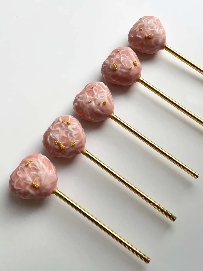 A row of Valentines Marble Heart Cake Pops (Pack Of 6, 12, 18, 24), placed on a white background.