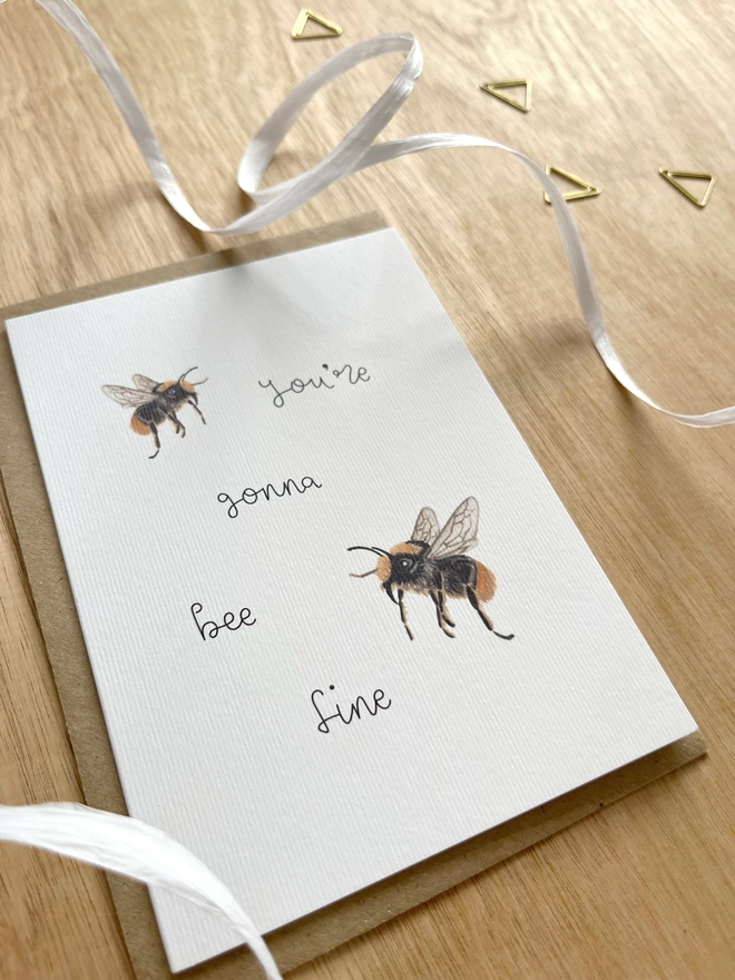 a greetings card featuring a couple of illustrated bees with the phrase “you’re gonna bee fine”