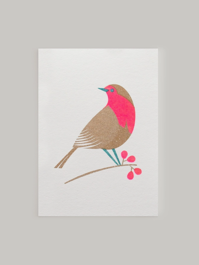 Bright pink and metallic gold inks highlight the details in the beautifully festive Robin. Risograph printed onto luxury, heavyweight card this retro influenced mini Christmas card makes the perfect way to send stylish and modern Christmas wishes.