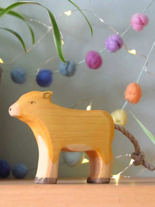 Jersey cow calf wooden toy on nursery room shelf