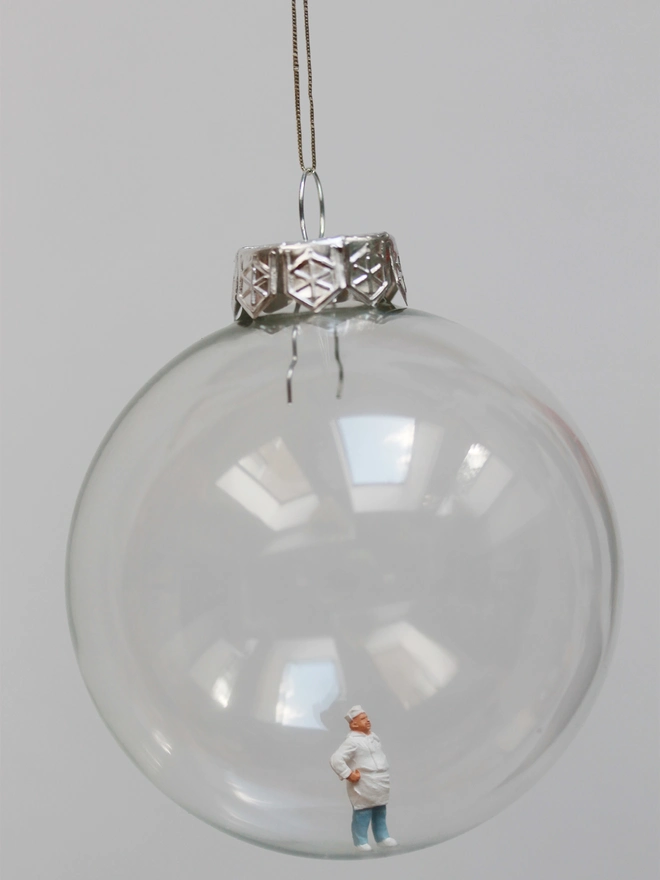 Miniature figure of a chef in a glass Christmas bauble 