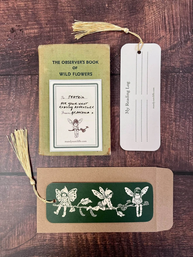 a flat lay photo of a pixie book mark laid on a kraft envelope with a sweet gift giving tage showing this can be used as a greeting card