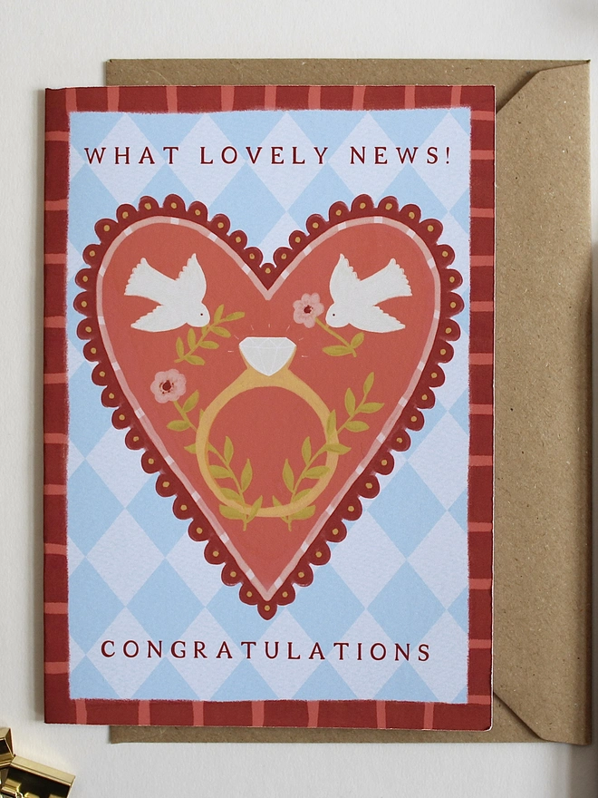botanical engagement card featuring love birds on a big heart with a ring