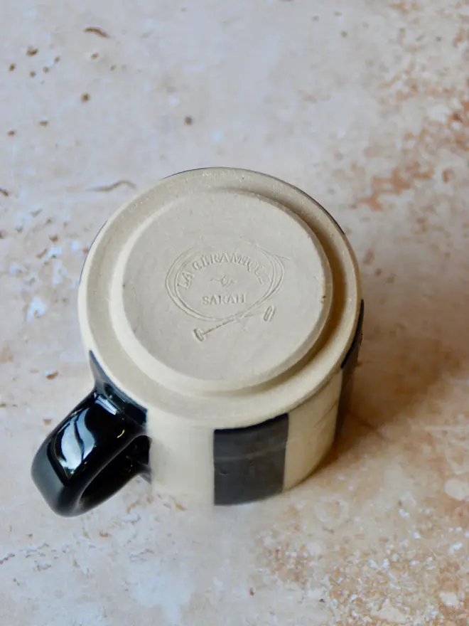 Le Petit Rayé handmade espresso cup base showing maker’s mark —-black and cream stripe