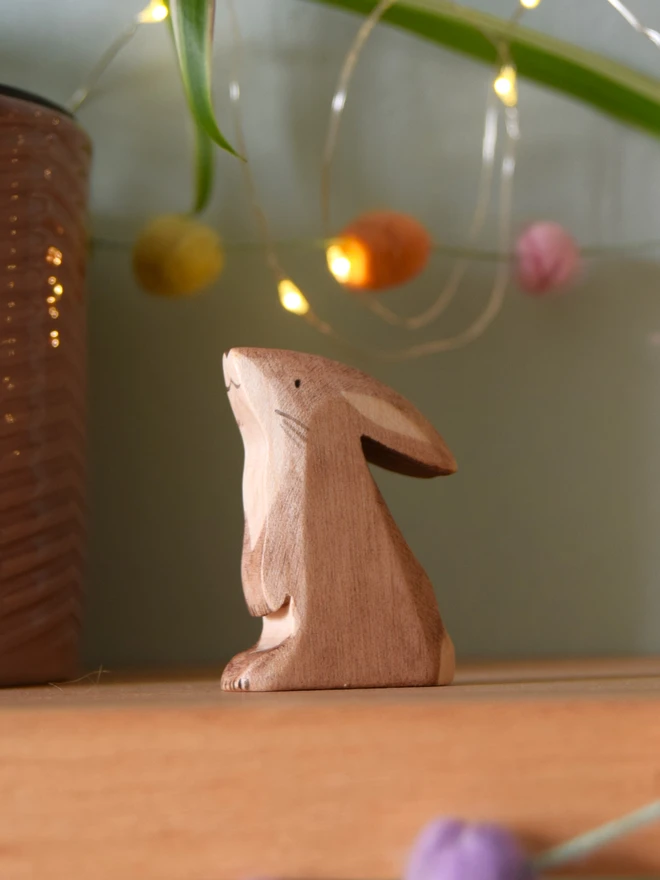 wooden brown rabbit peering up made by eric and alberts