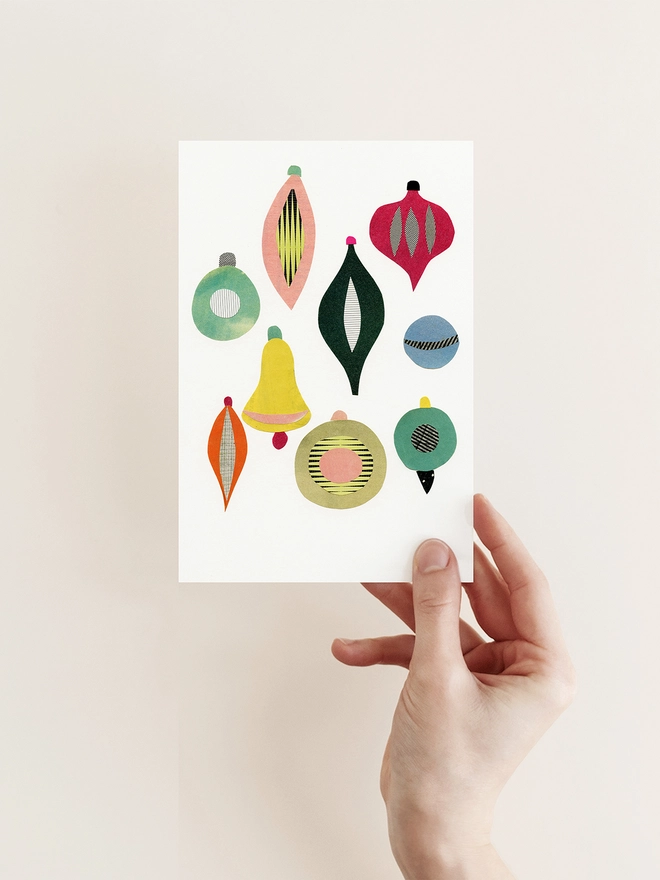 A Christmas card featuring a collection of colourful mid century baubles.
