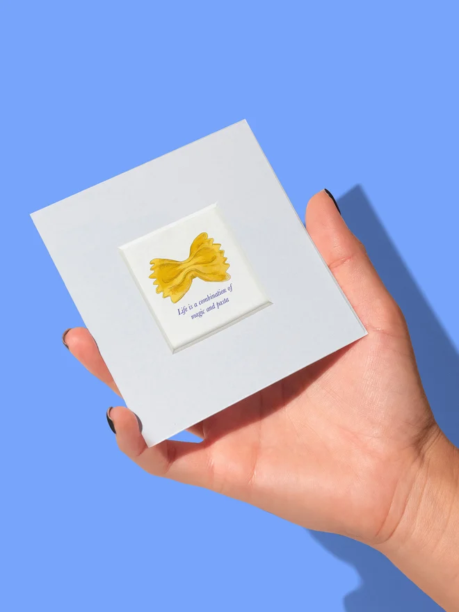 Hand holding Mini Print showing size 