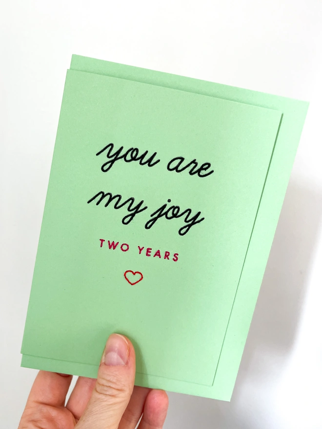 Bespoke card script and contemporary font on mint card