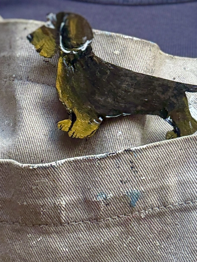Wire Haired Dachshund wooden hand-painted pin  badge pinned to an apron