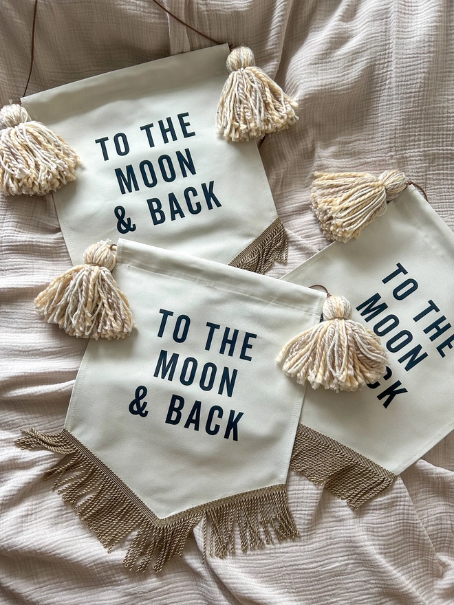 To the Moon and Back fabric printed banner with neutral caramel tassels and gold trim