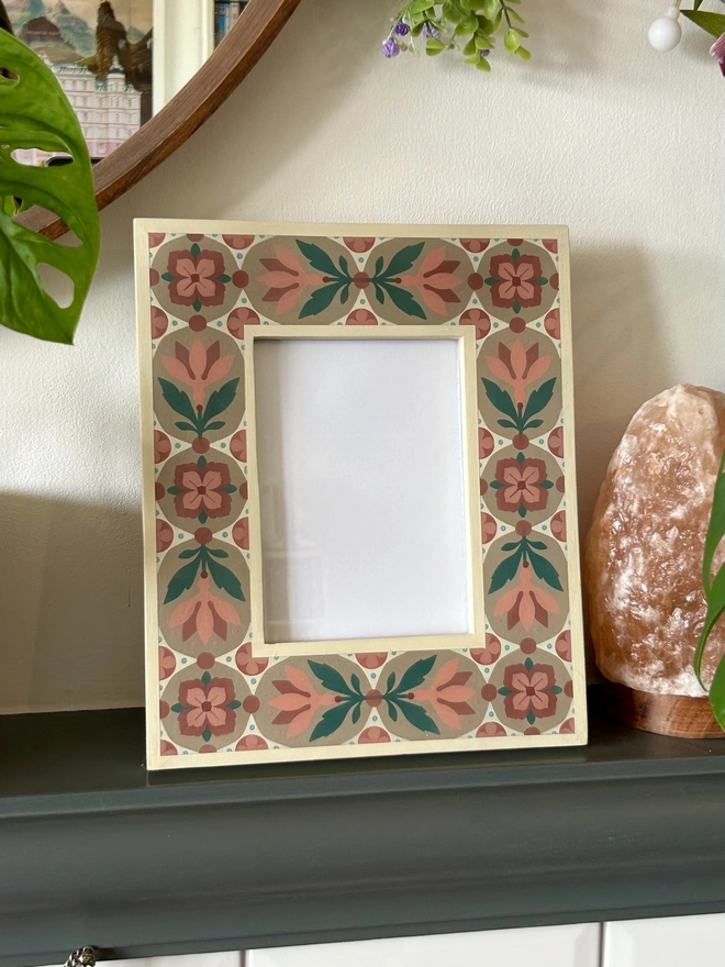 Folk art inspired hand painted decorated flower patterned photo frame painted in pinks, green, cream and light brown