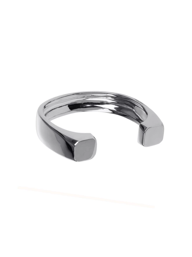 a highly polished solid silver weighty bold cuff with facetted square details on front