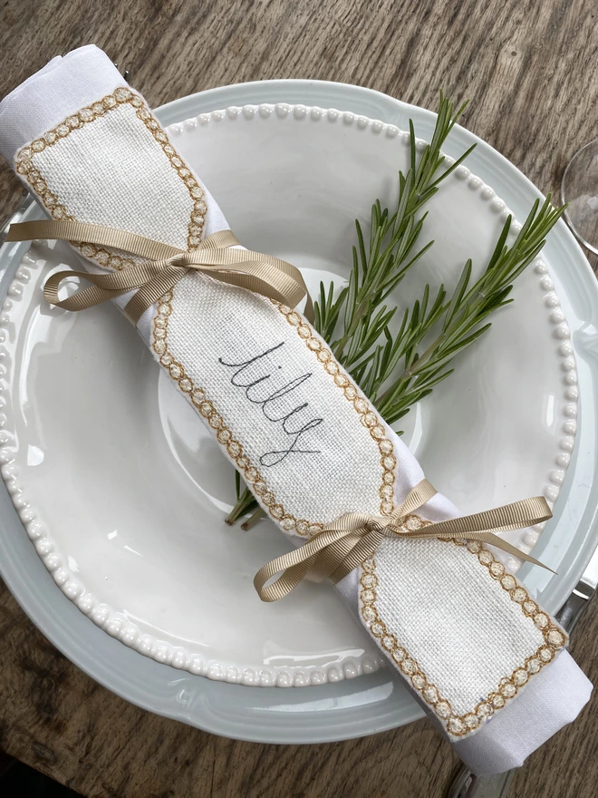 Fabric Cracker Napkin Decoration on plate with rosemary