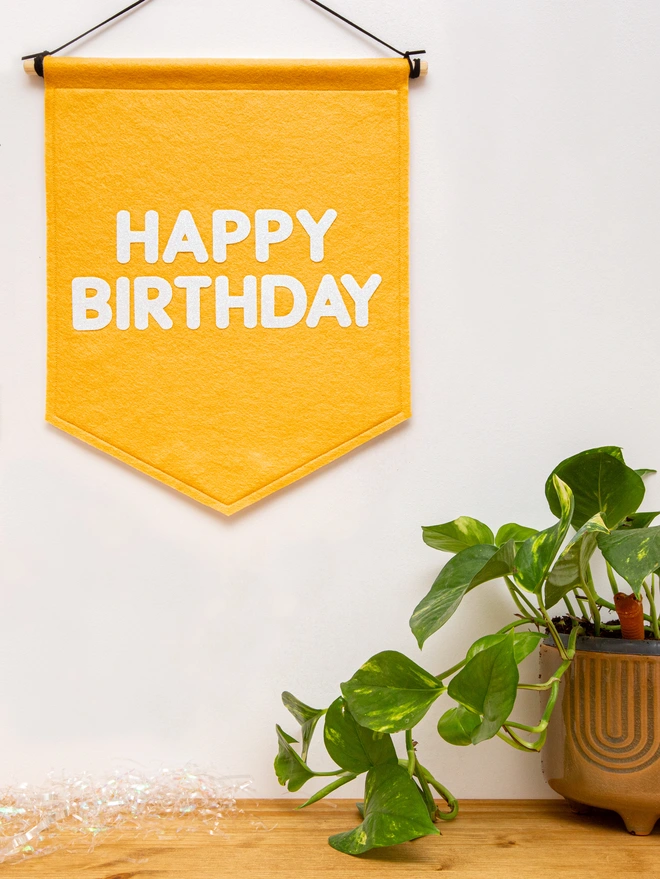 happy birthday banner in mustard felt and white glitter