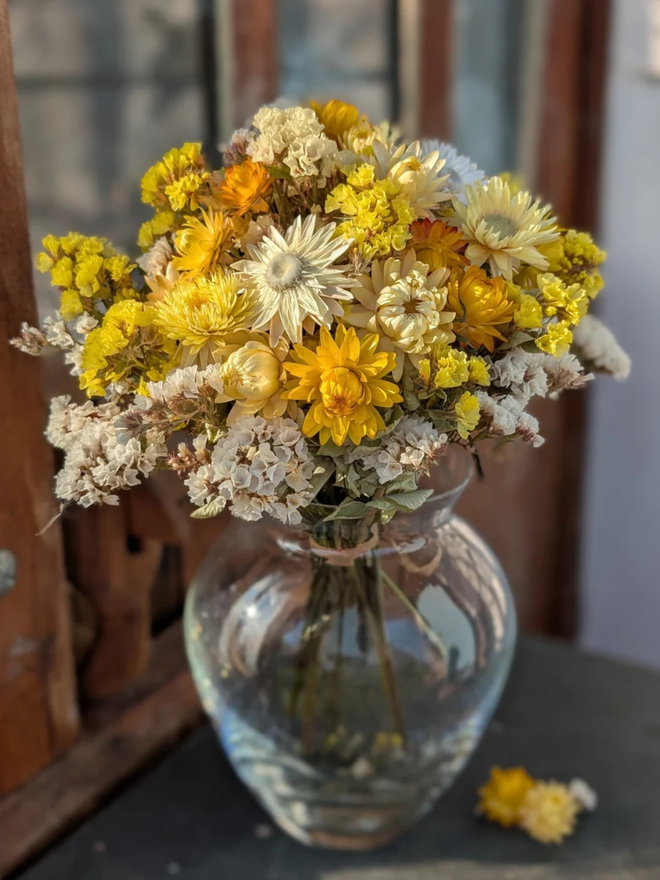 golden sunshine dried flower bouquet. bouquet of dried yellow flowers in a vase.