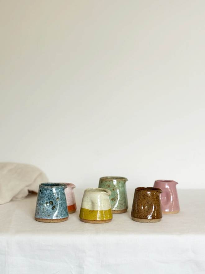 Pinch Jug. A selection of Mini Pinch Jugs in Blue, Orange, Yellow, Green and Pink.
