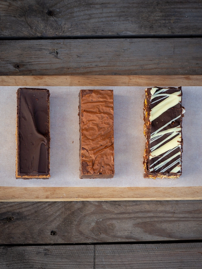 Squidgy brownie on the bottom covered in a thick layer of our handmade caramel then topped with a layer of real dark chocolate