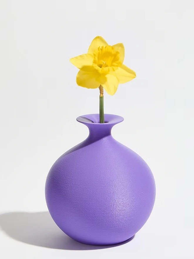 round shaped 3d printed vase in purple with yellow flower