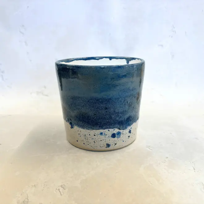 Shoreline Large Pot, a colourful pot placed on a stone surface. 