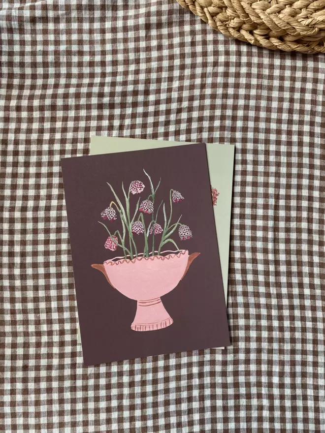 print with fritillaria also known as snakes head flowers in a pink vase.