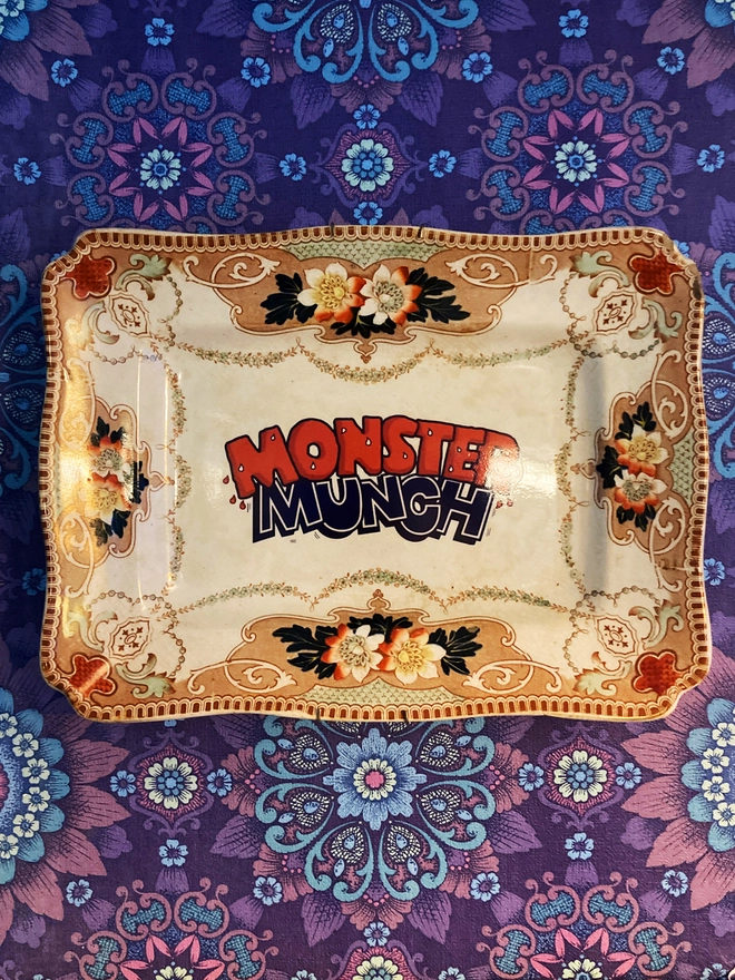 Vintage decorative 'Monster Munch' plate mounted on wall.