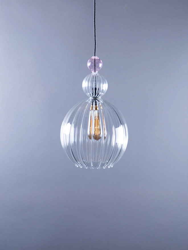 Medium clear glass, handblown pendant light. Shown here with a large  clear ribbed bauble and a smaller pink bauble stacked on top. 