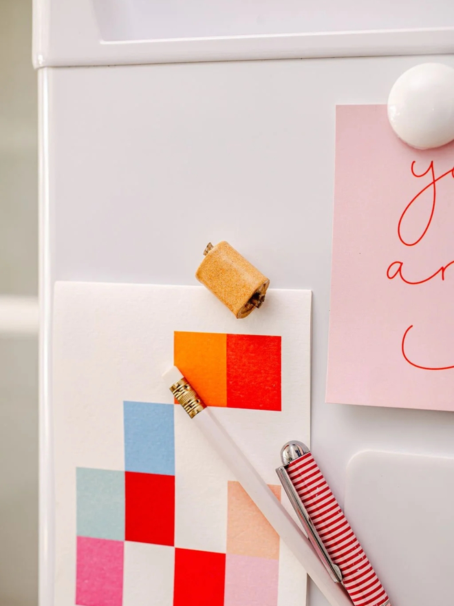 ceramic pastry magnets. a ceramic pain au chocolat magnet on a fridge door.