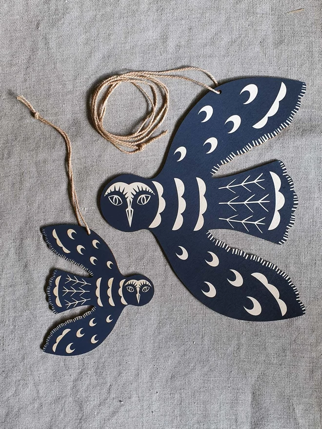 Hanging wooden, hand printed, large and small solstice owl decoration in midnight blue.