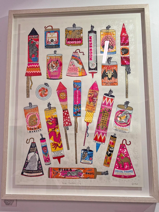 Fireworks Screenprint Snap, Crackle, Pop, a collection of colourful fireworks on a white screenprint. It sits framed against a white wall. 