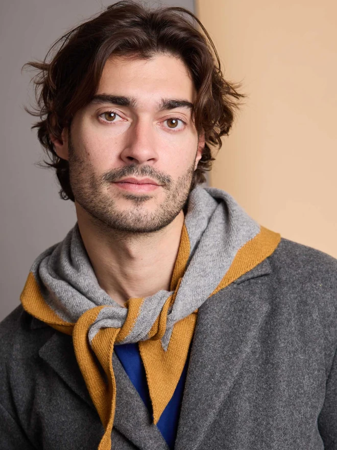 man wearing grey and mustard wool neckerchief