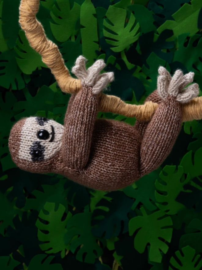 Sloth Knitting Kit. A knitted sloth on a branch.