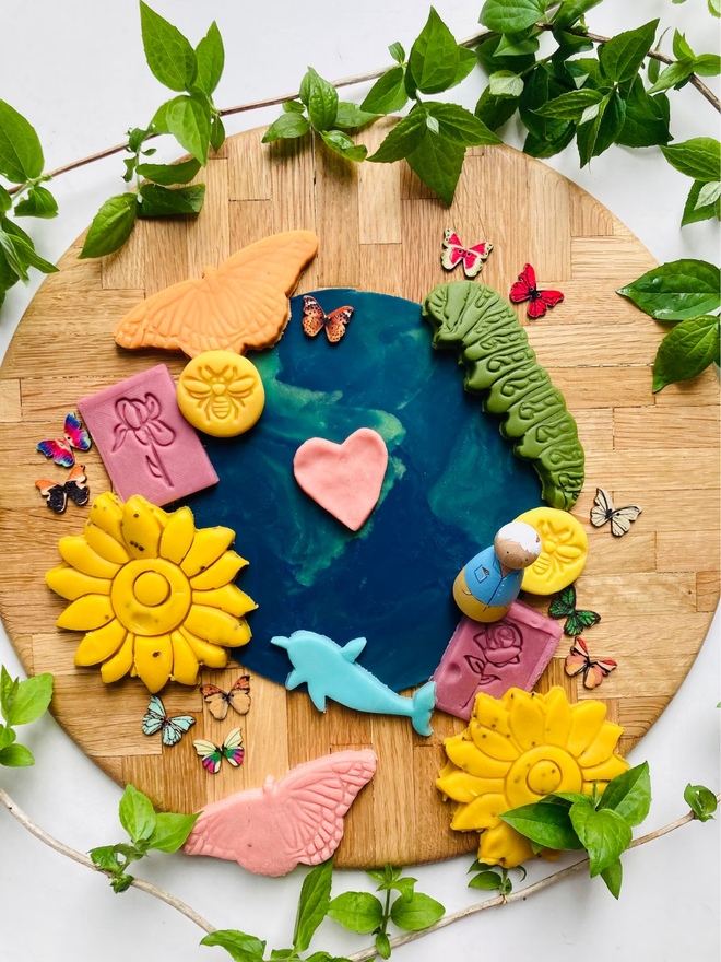 earth sensory play dough. a craft set up with earth blue and green play dough.