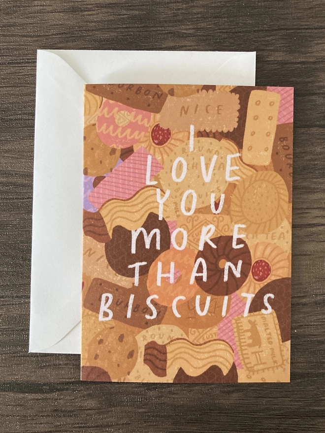 Card full of biscuit illustrations, with "I love you more than biscuits" overlaid in handwritten text