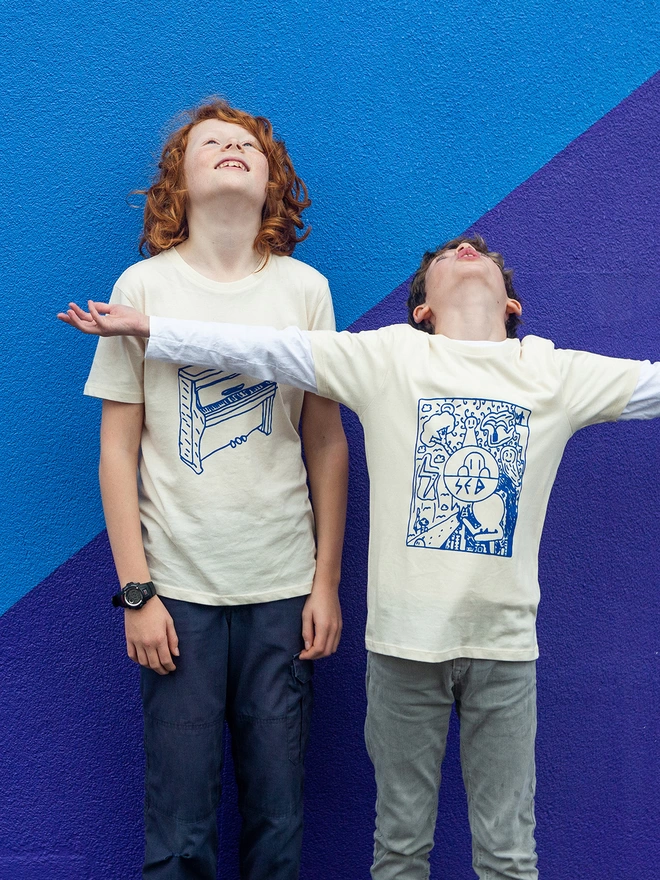 two boys wearing their own hand drawn then screen printed t-shirts