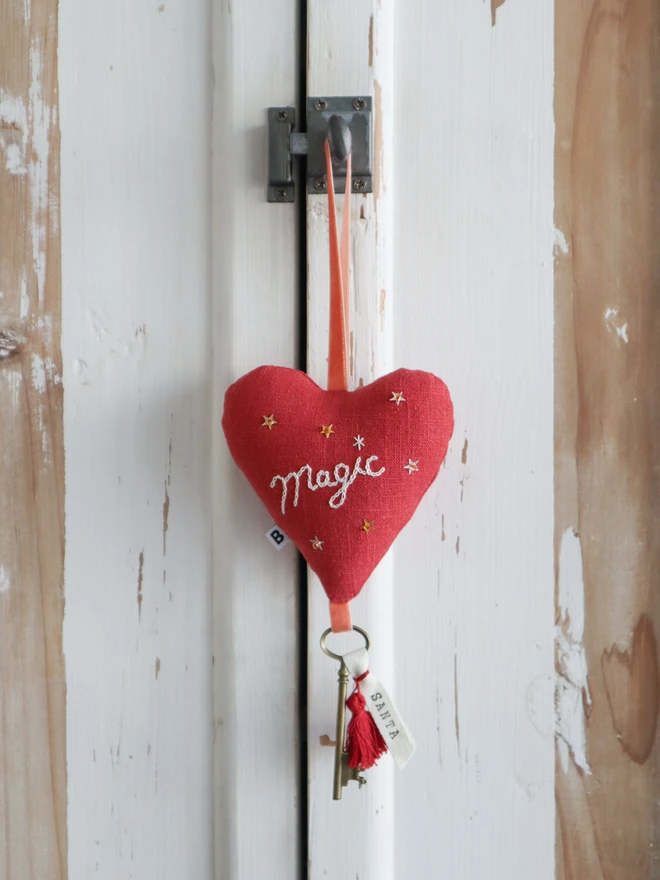 Linen heart ornament with Magic embroidery, hanging rustic key with Santa's name tag and red tassles