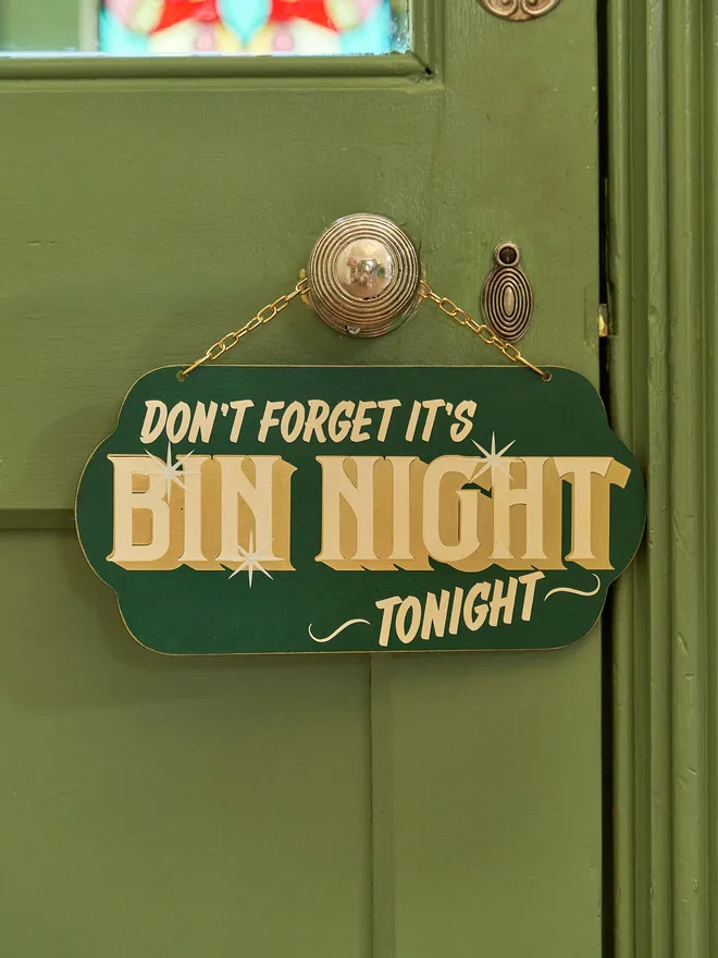 green 'dont forget it's bin night tonight' sign with gold text and hanging chain