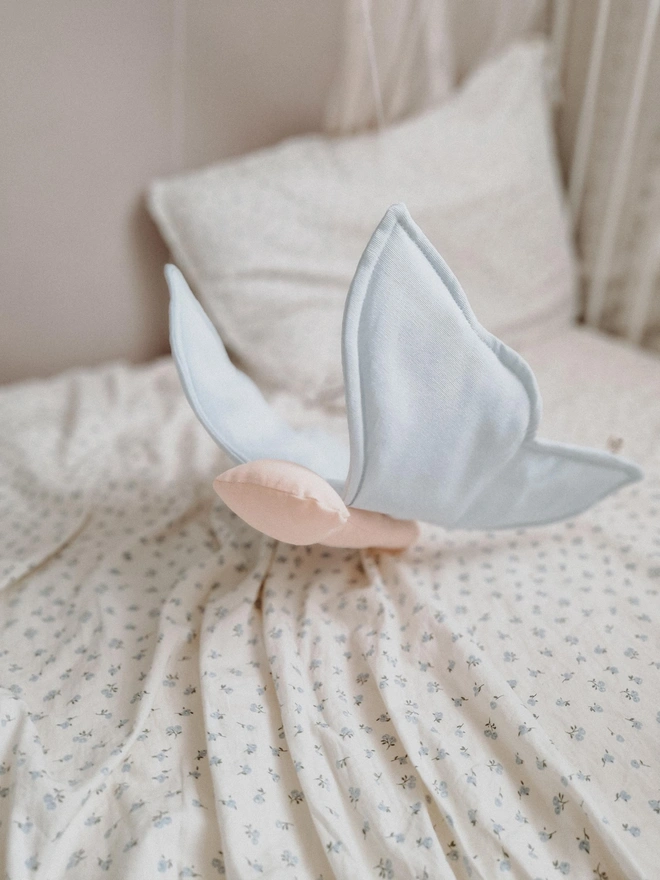 Butterfly Nursery Decoration, a colourful butterfly decoration sitting on a child's bed. 